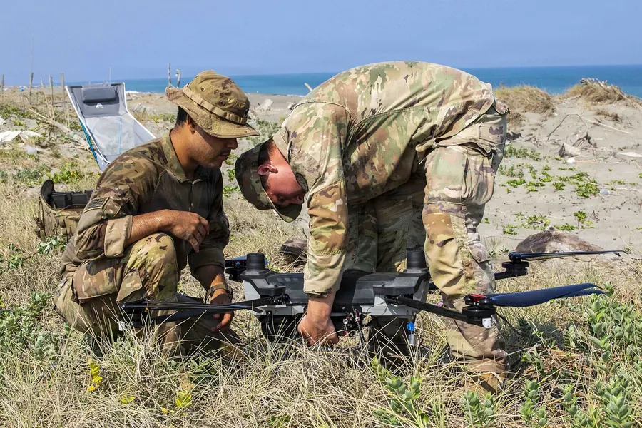 Two soldiers preparing a drone in the field